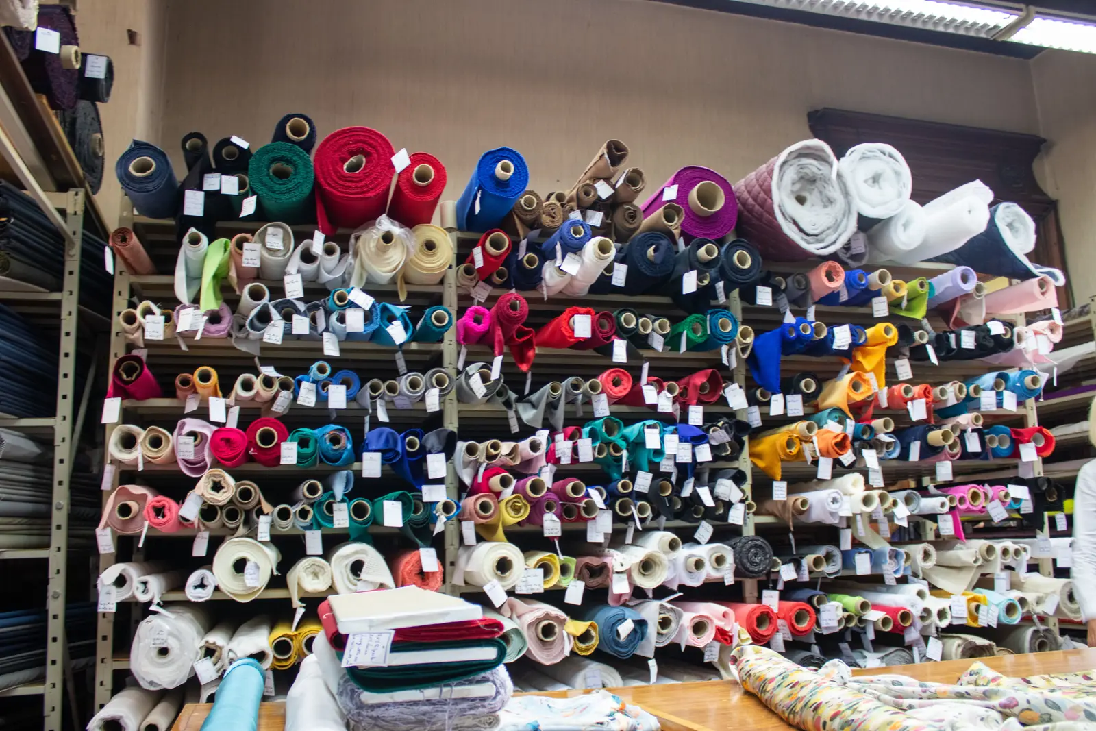 Shelves of coloured fabric rolls