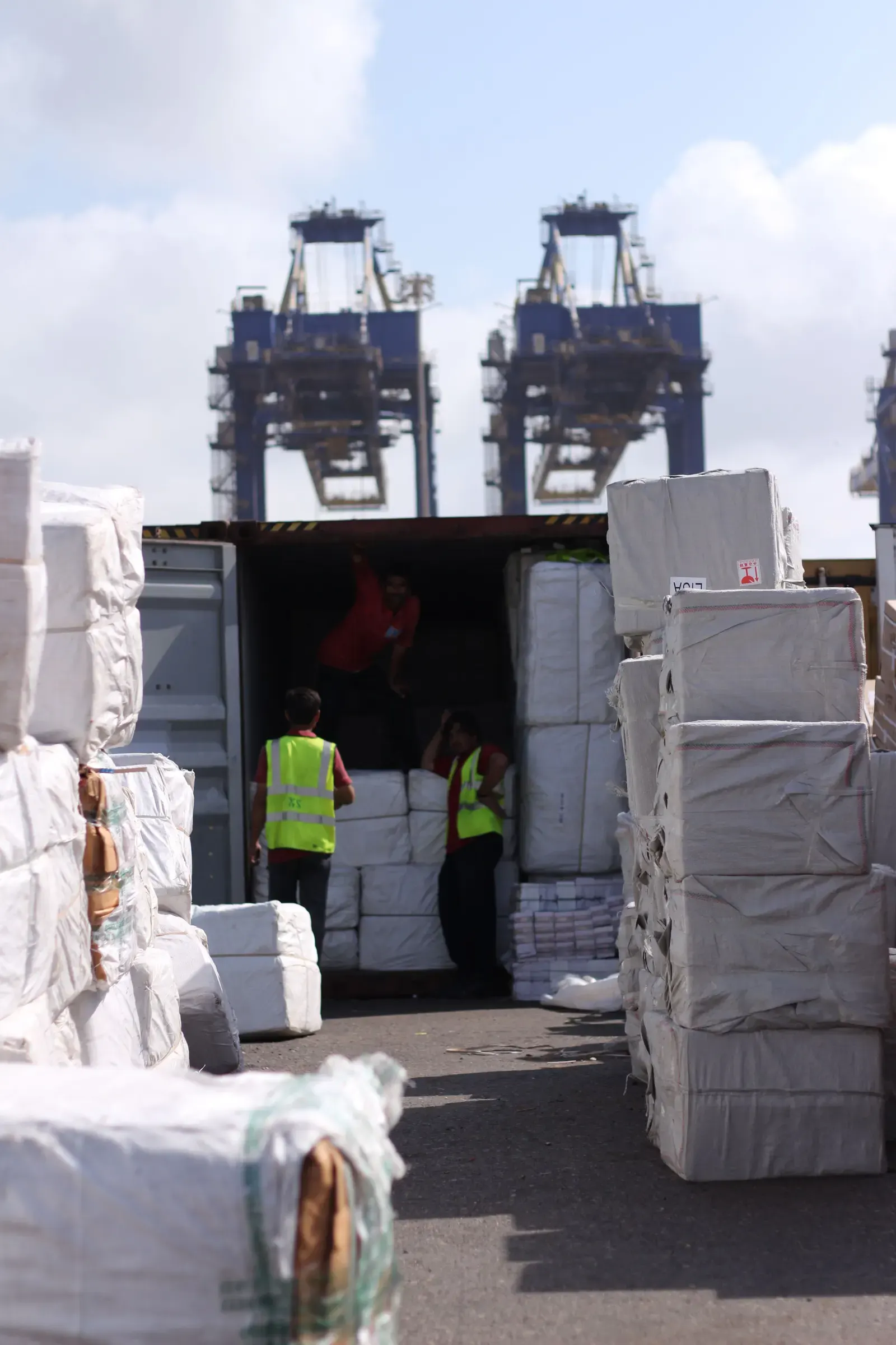 Workers loading cartons into a shipping container