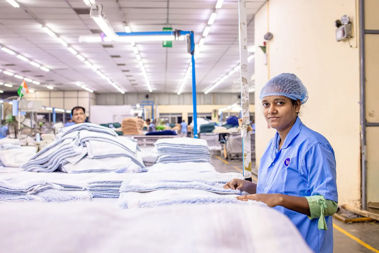 Worker at an inspection table in a textile factory