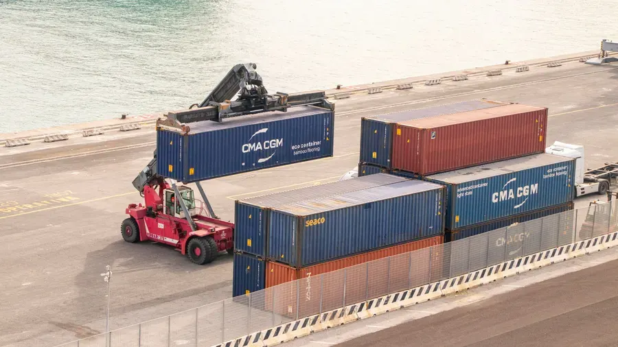 Reach stacker moving shipping containers at a port