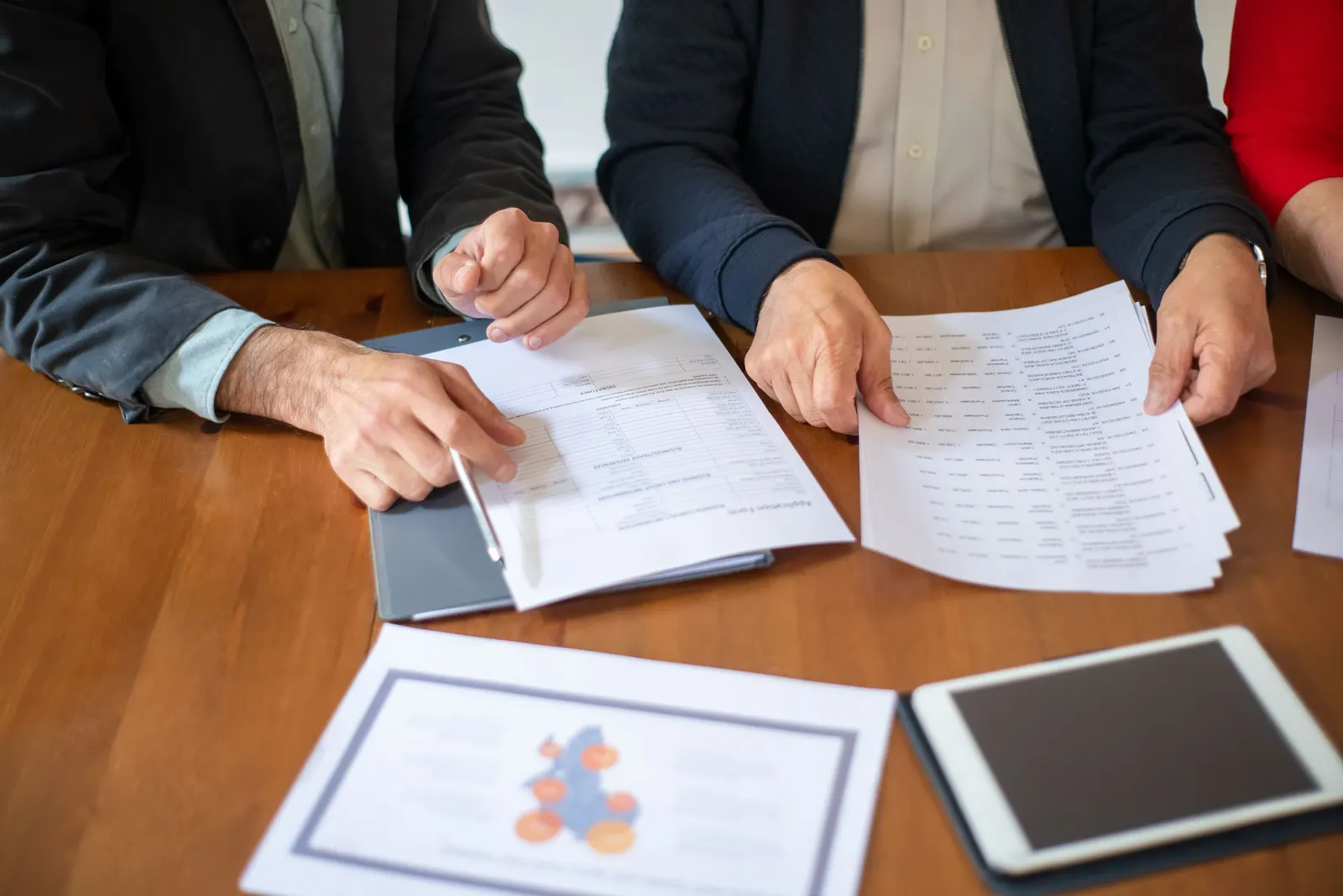Two buyers reviewing documents in a meeting