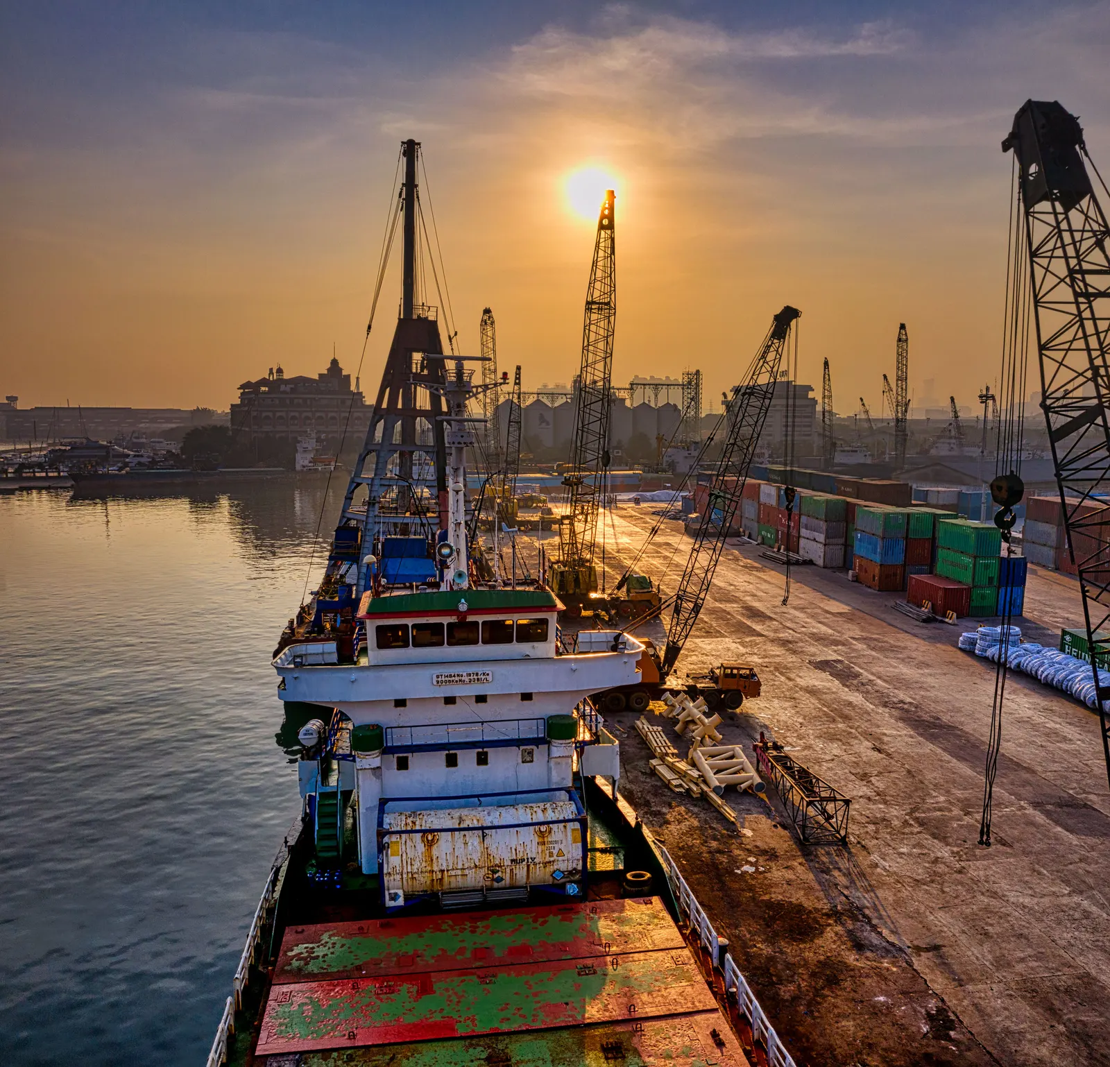 Container cranes at a port at sunset